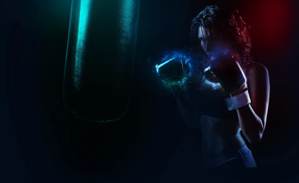Boxer in gloves training beside a punching bag