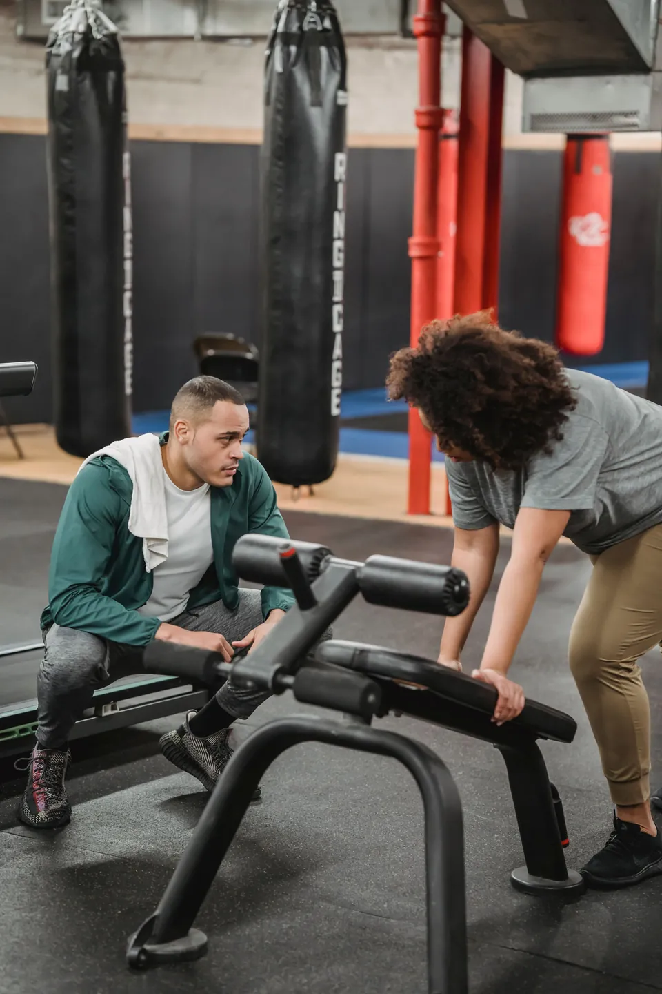 Coaches helping an athlete develop strength and technique